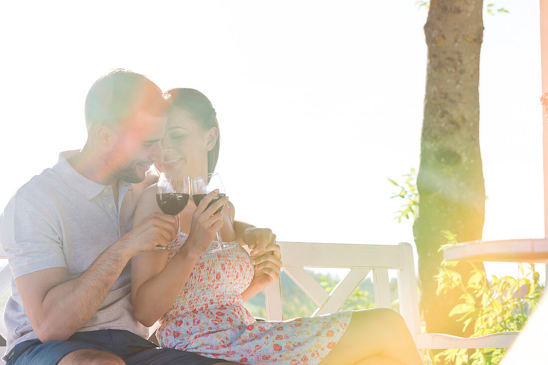 Couple hugging and drinking red wine