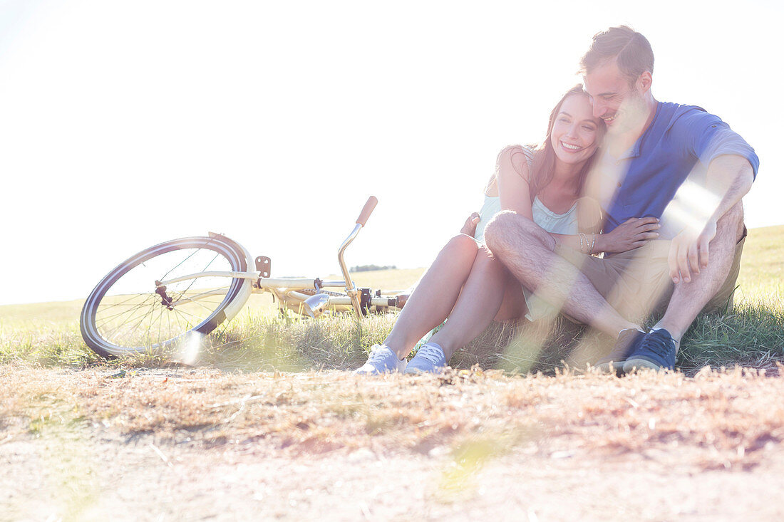 Couple hugging in rural grass