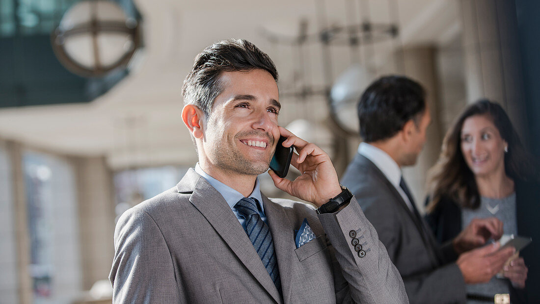 Smiling Businessman talking on cell phone
