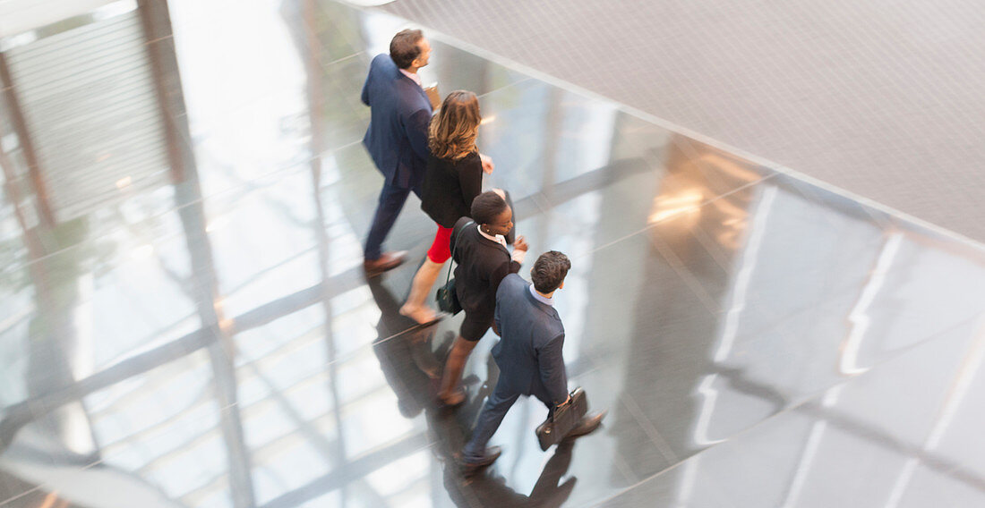 Business people walking in a row lobby