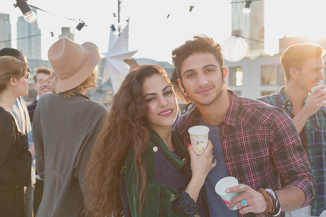 Portrait smiling young couple drinking