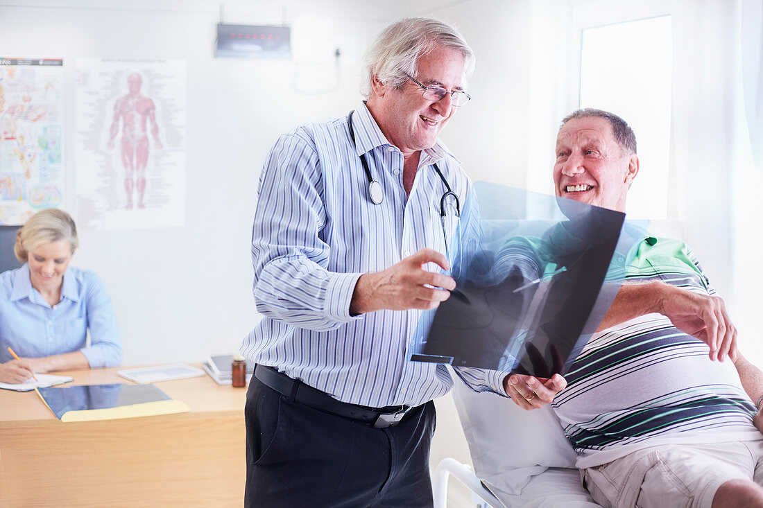 Doctor showing senior man x-ray