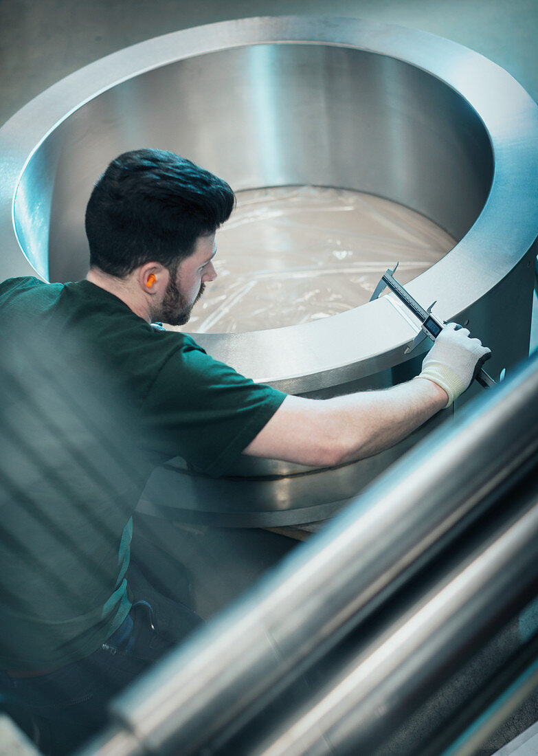 Worker measuring piece with calipers