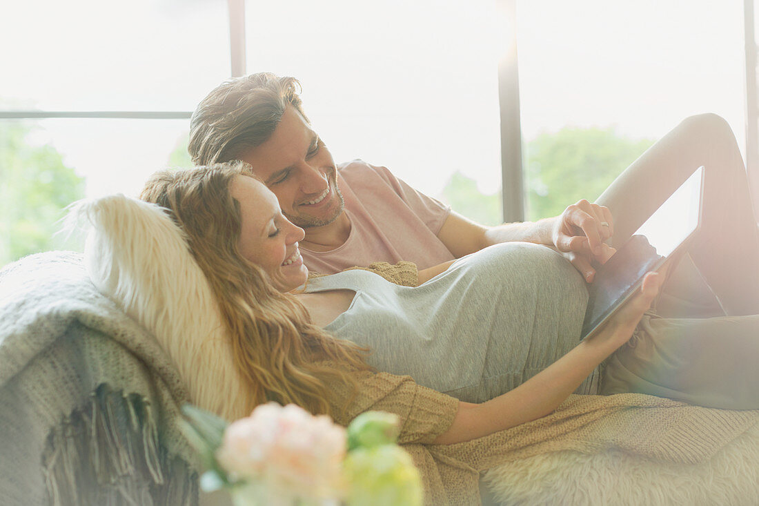 Pregnant couple laying relaxing