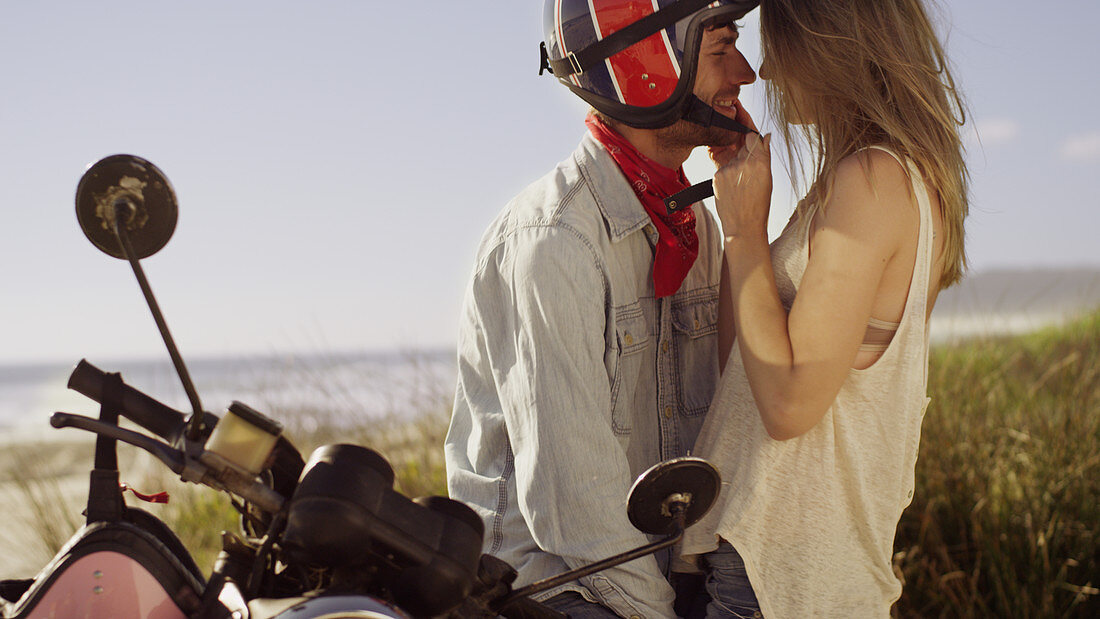 Affectionate young couple at motorcycle