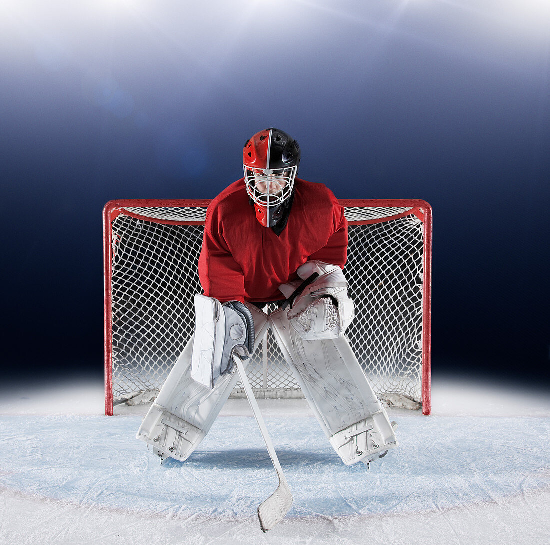 Hockey goalie protecting goal net on ice