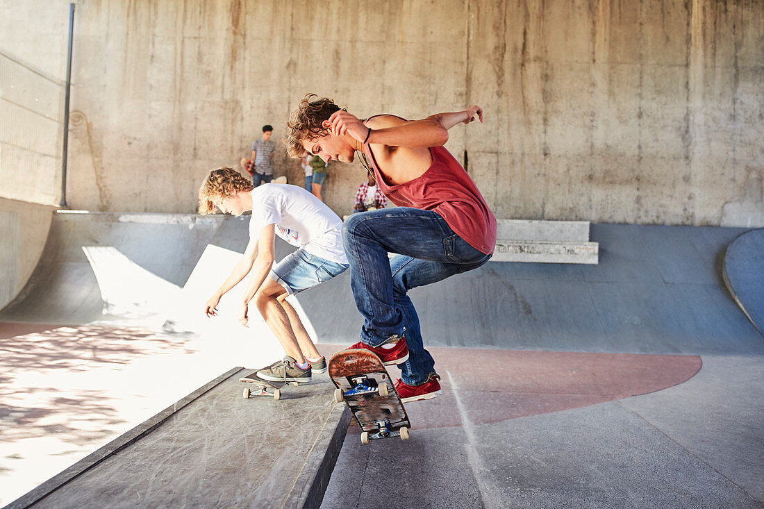 Teenage boys skateboarding at skate park