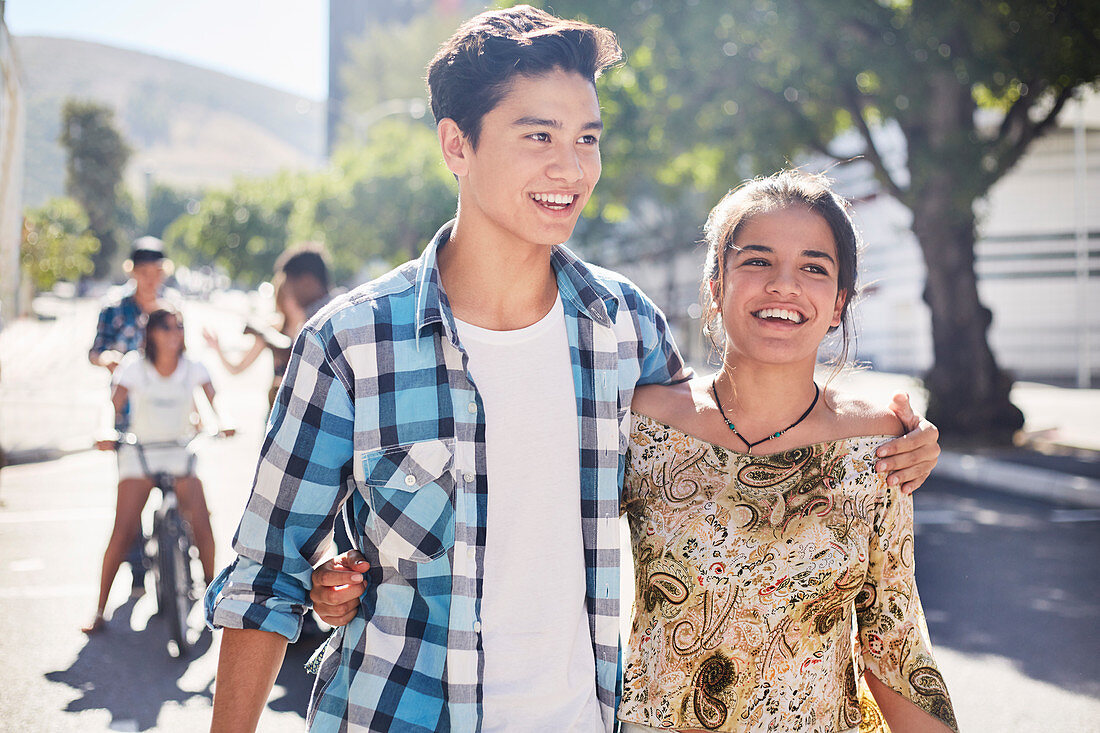 Smiling teenage couple walking