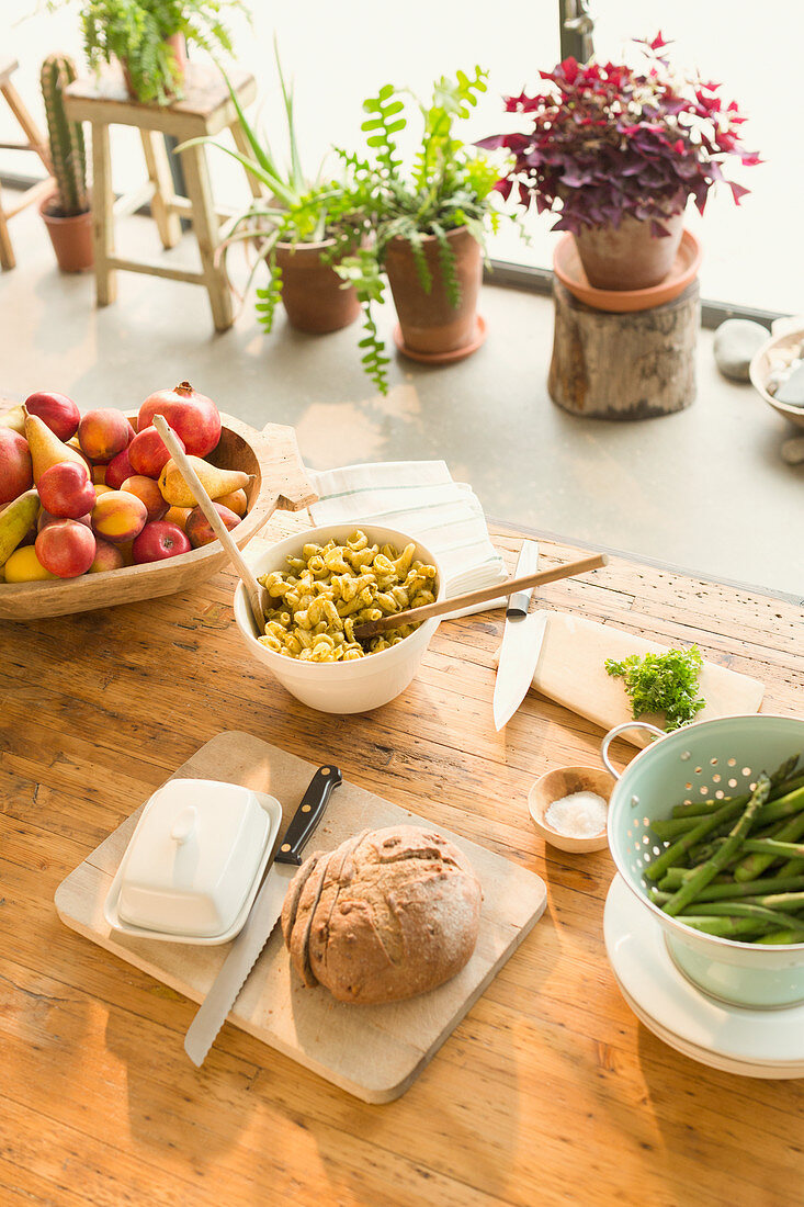 Pasta, fruit, bread, butter and asparagus