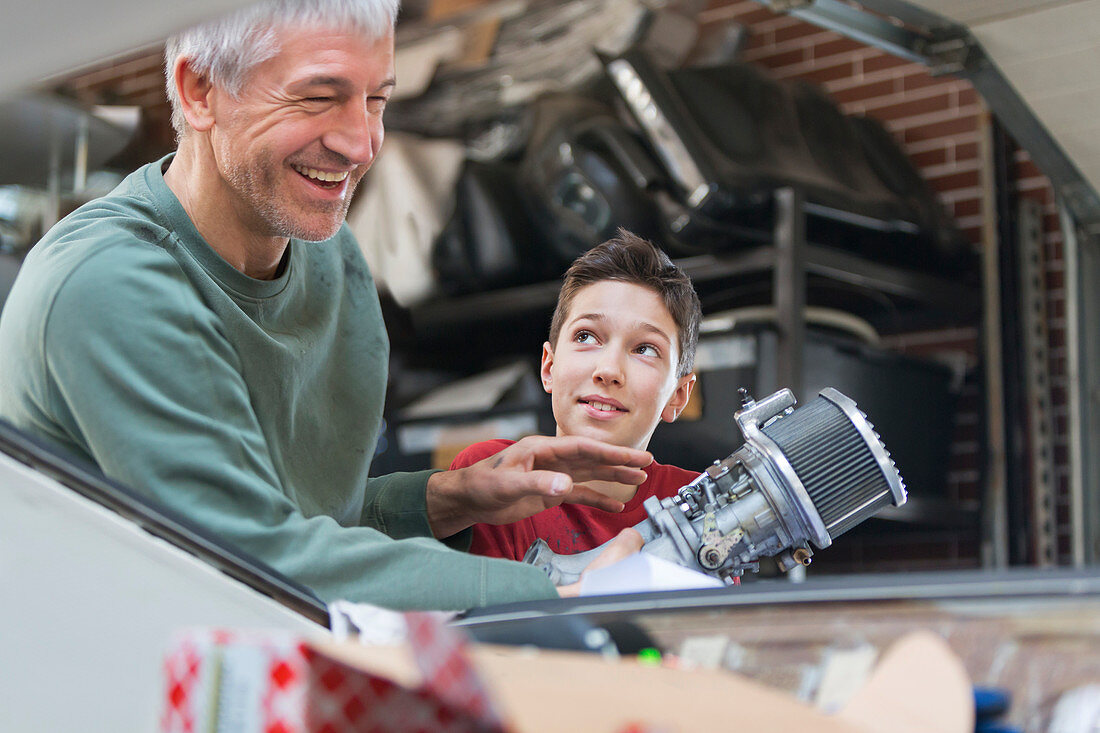 Father and son fixing car engine