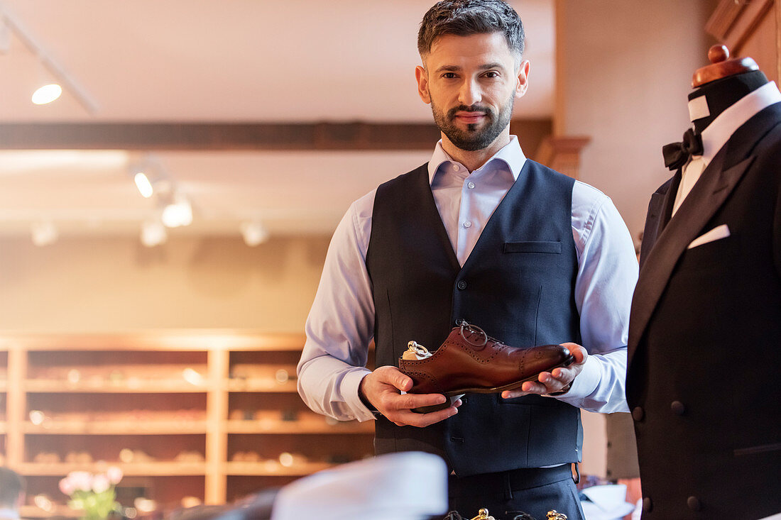 Businessman holding dress shoe