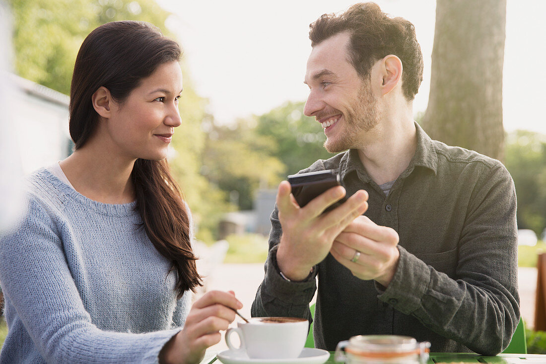 Couple drinking coffee at outdoor cafe