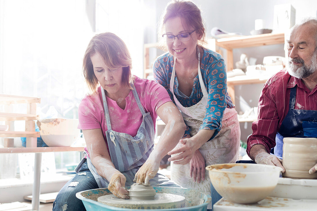 Mature student using pottery wheel