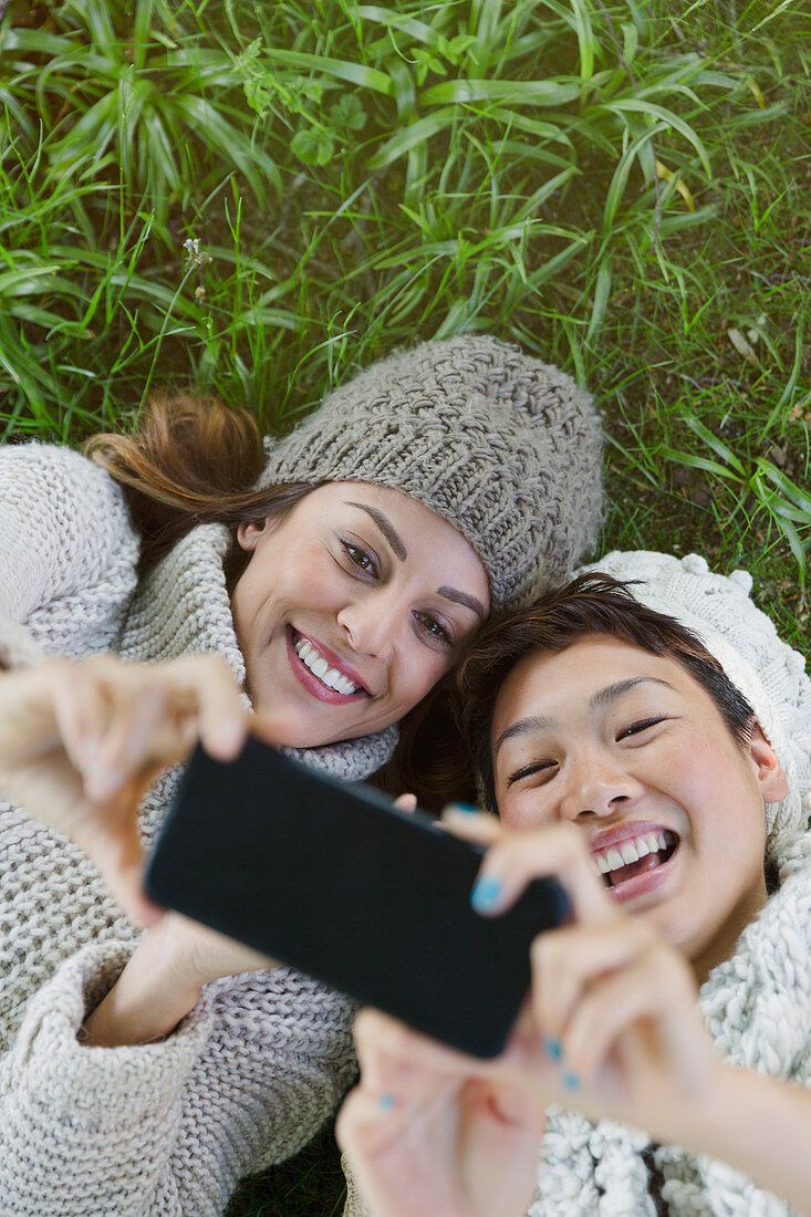 Women taking selfie in grass