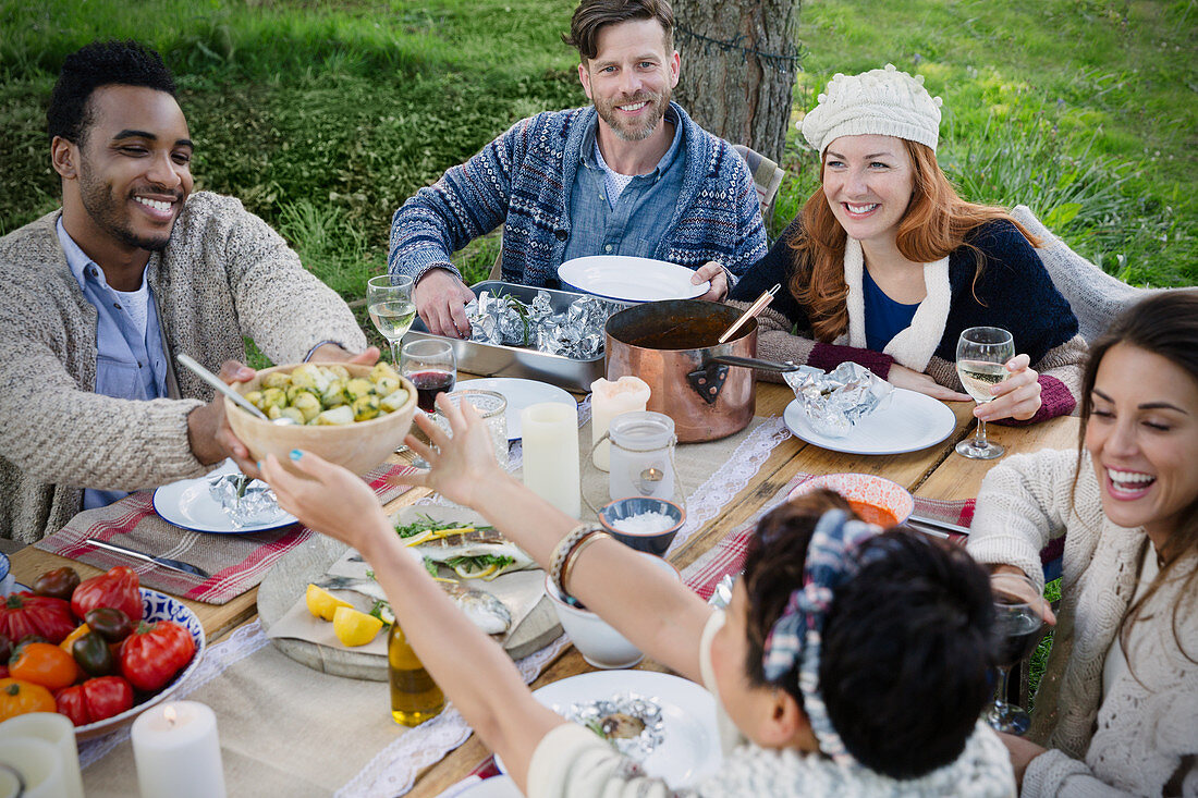 Friends eating lunch at patio table