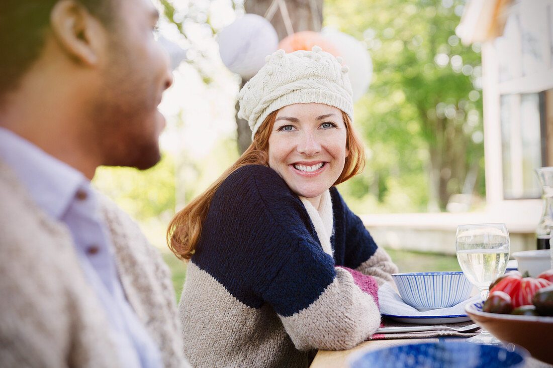 Smiling woman at patio lunch table