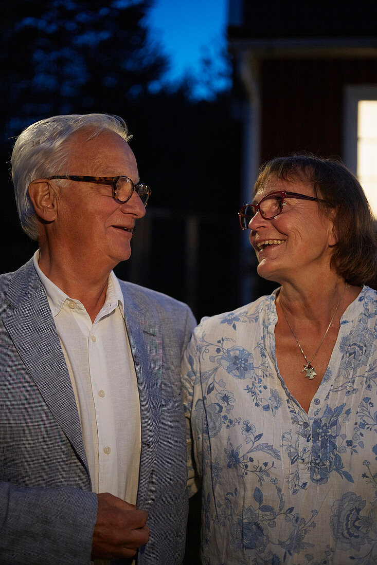 Senior couple smiling face to face