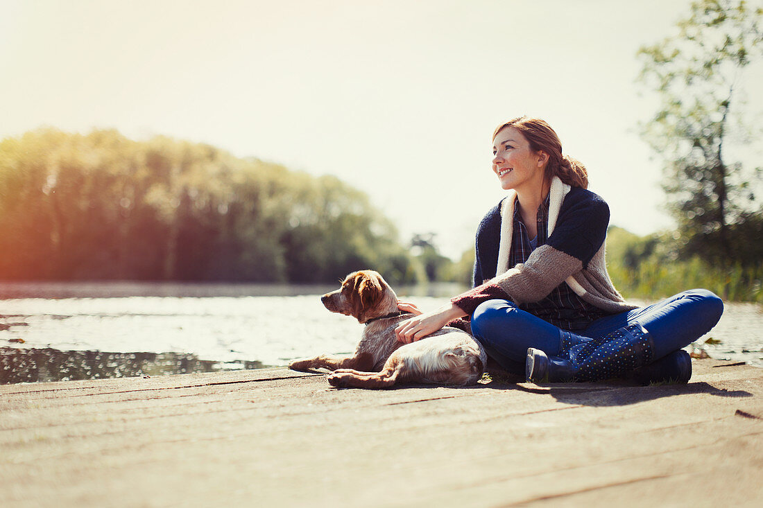 Smiling woman and dog relaxing