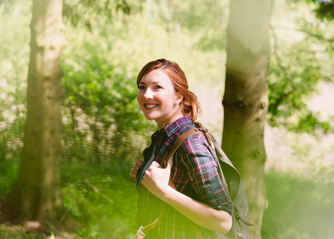 Smiling woman with backpack hiking