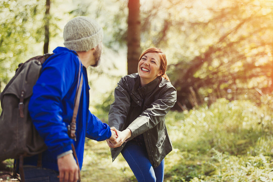 Smiling couple hiking in woods