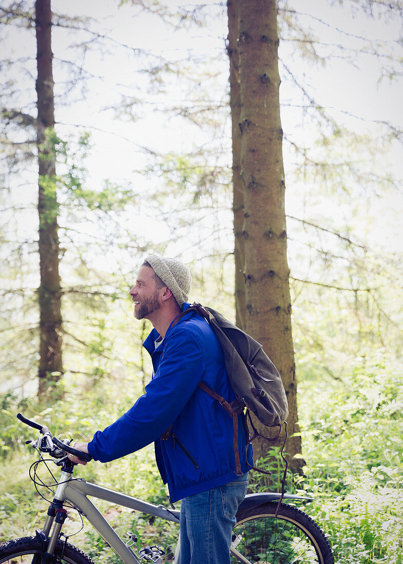 Man with mountain bike in woods