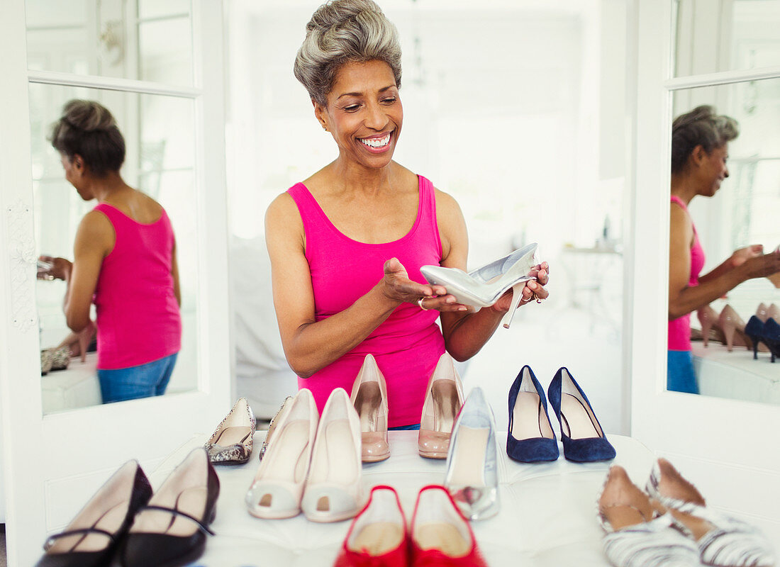 Smiling mature woman looking at high heels