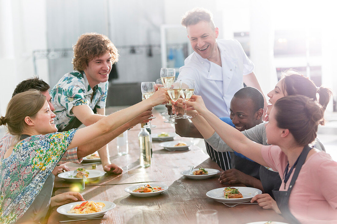 Chef teacher and students toasting