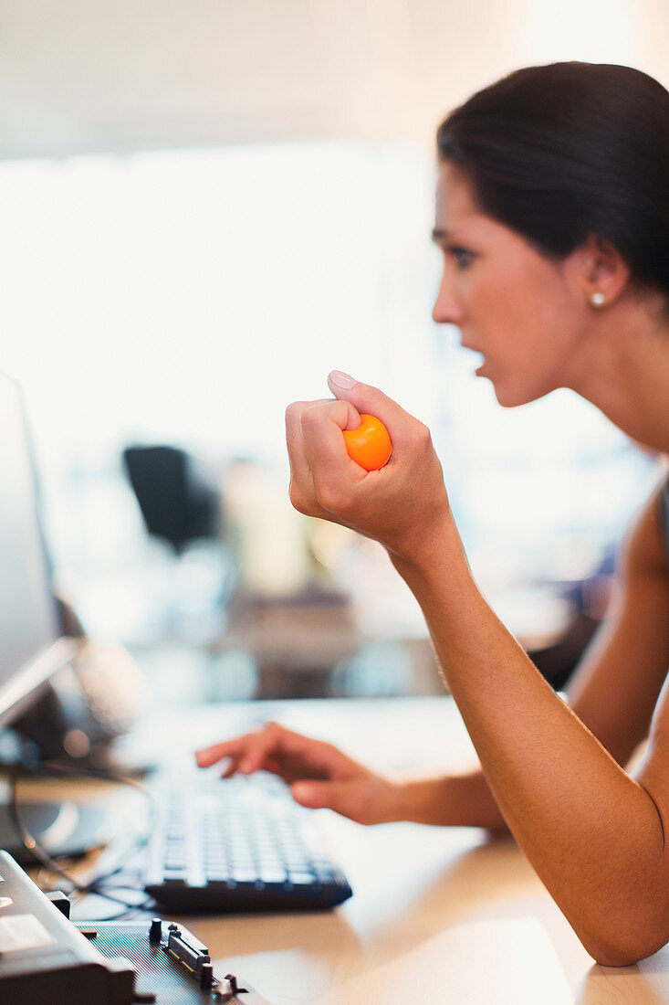 Businesswoman squeezing stress ball