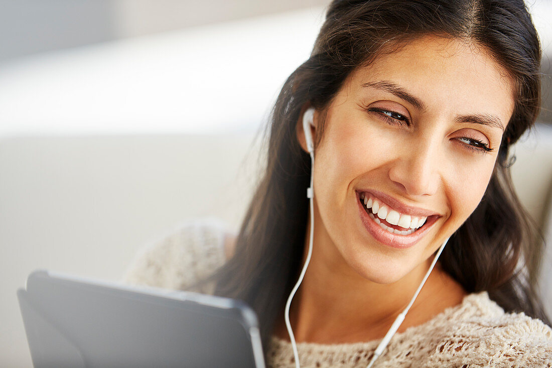 Close up smiling woman using digital tablet