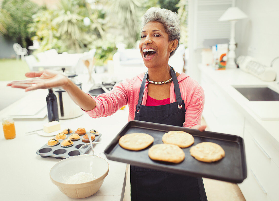 Mature woman baking cookies and kitchen