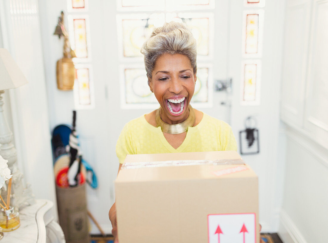 Mature woman receiving package in foyer