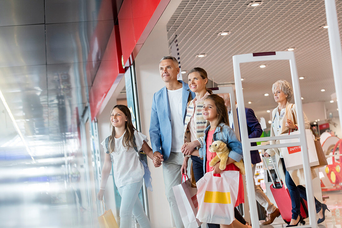 Family leaving duty free shop at airport