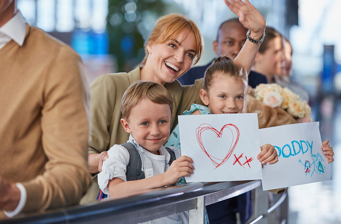 Mother and children with welcome signs