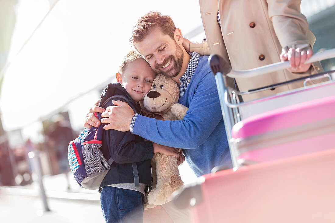 Father and son hugging outside airport