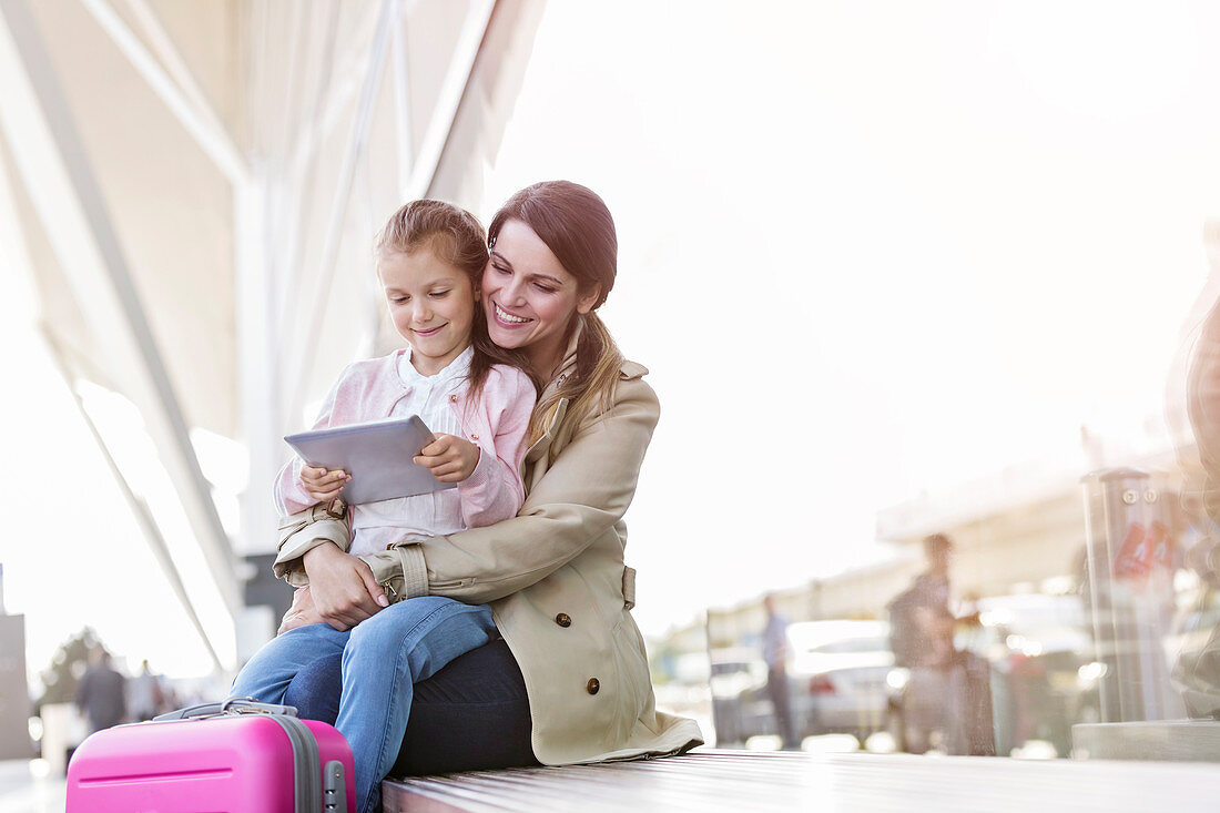 Mother and daughter outside airport