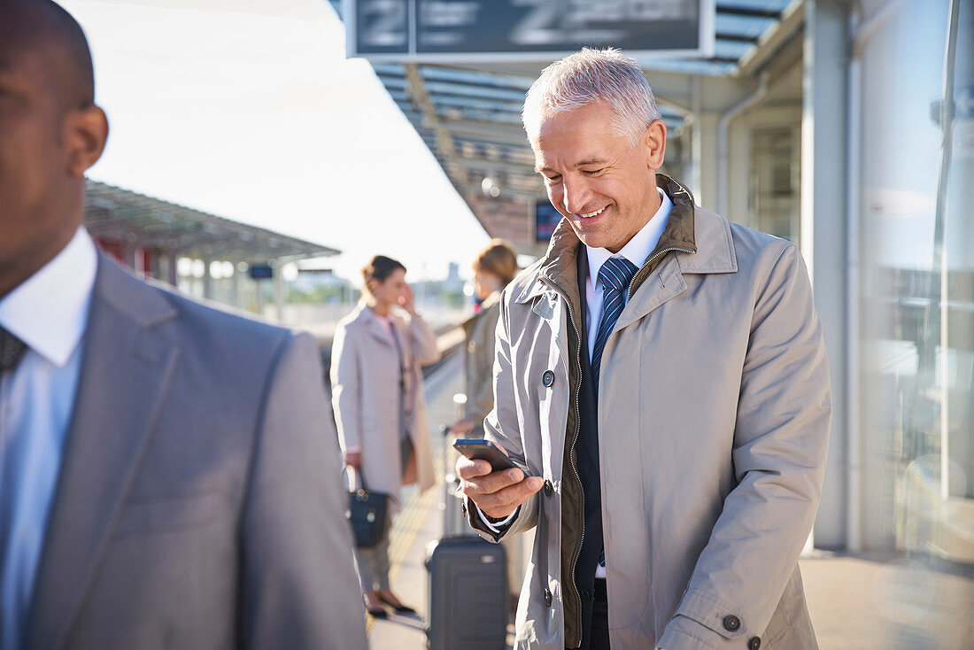 Businessman texting with cell phone