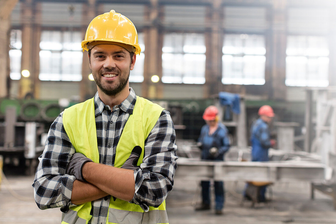 Portrait smiling confident steel worker in factory