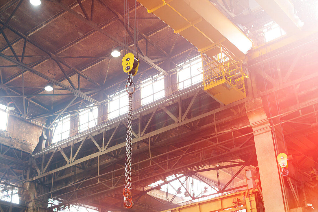 Chain hanging from crane in steel factory