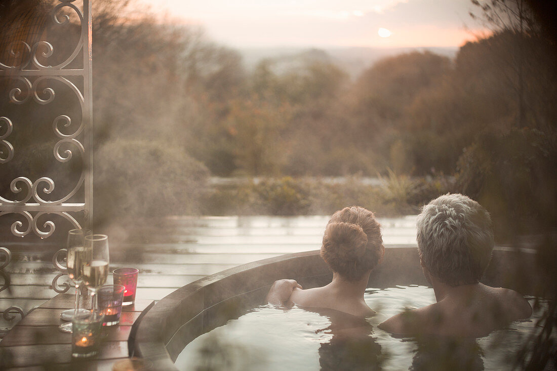 Serene couple in hot tub looking