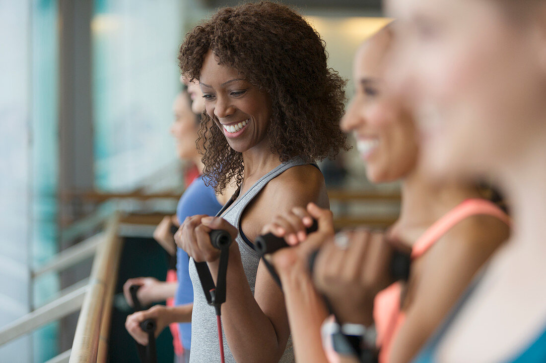 Smiling women using resistance bands