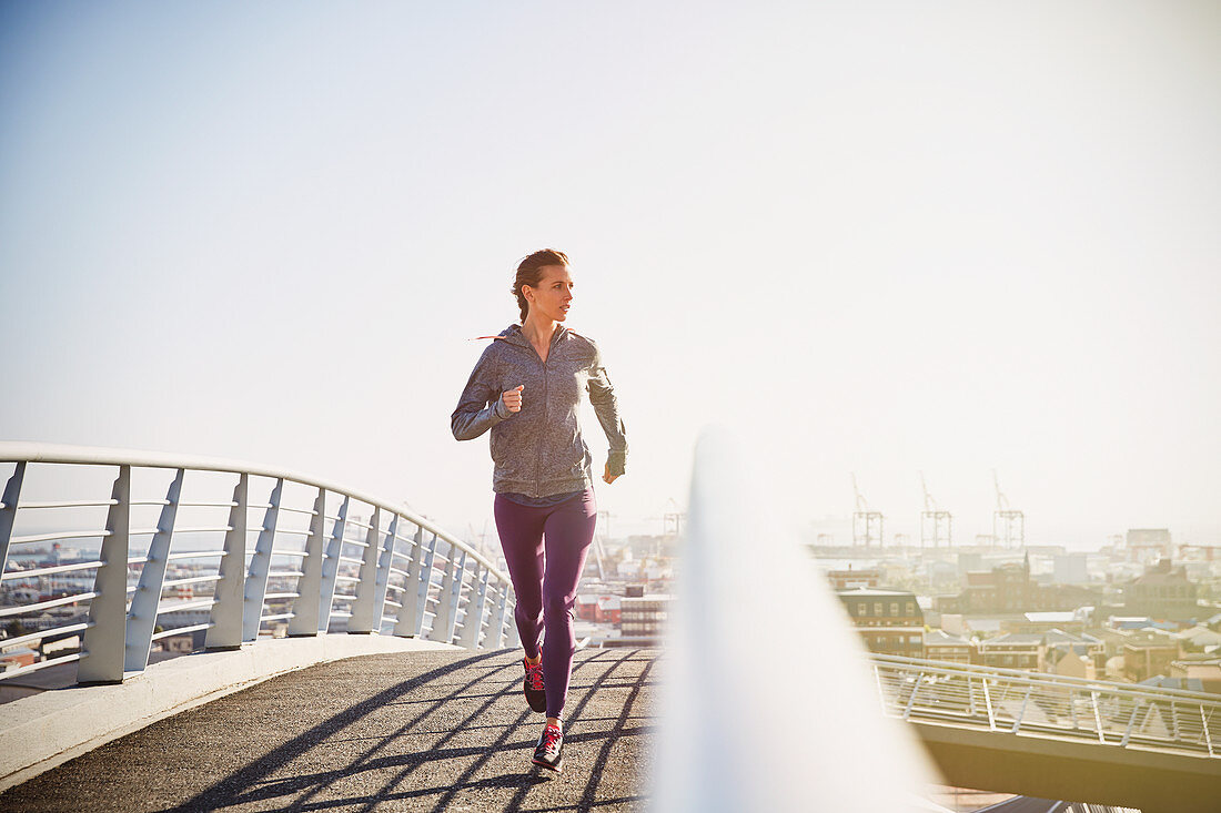 Female runner running at sunrise