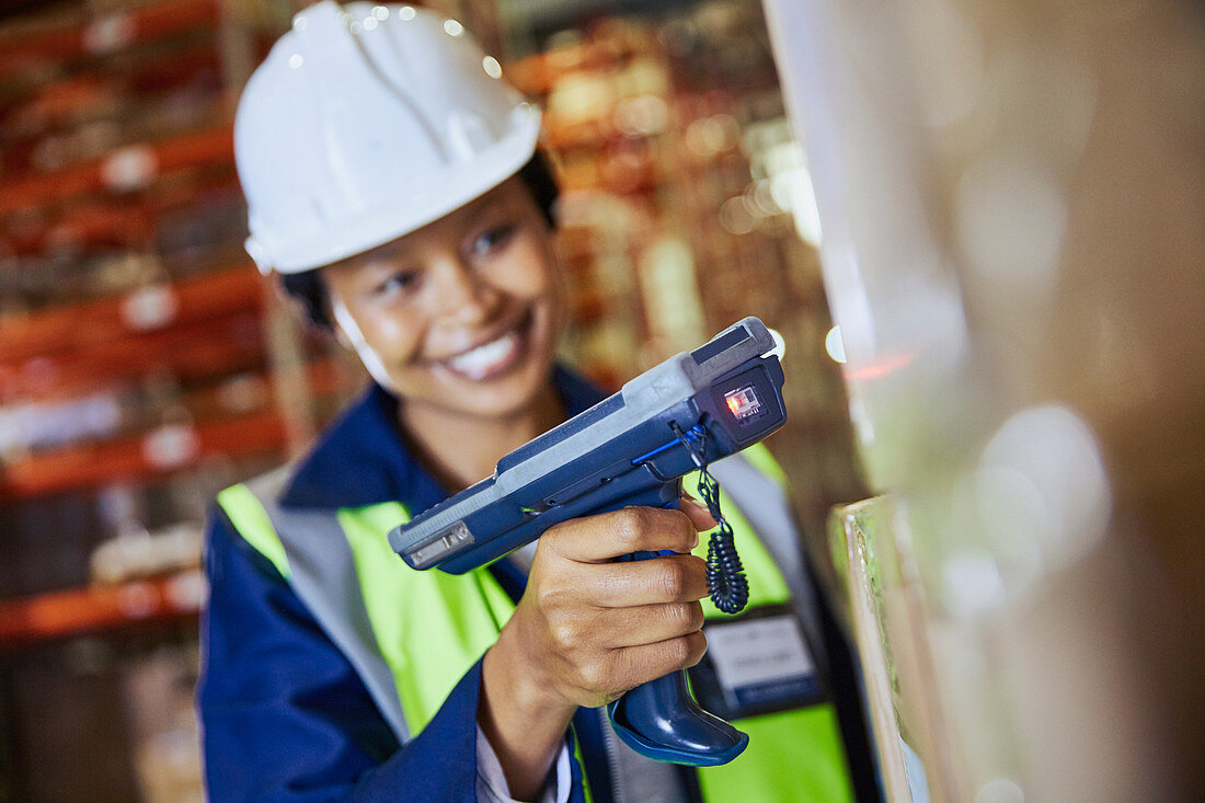 Smiling female worker using scanner