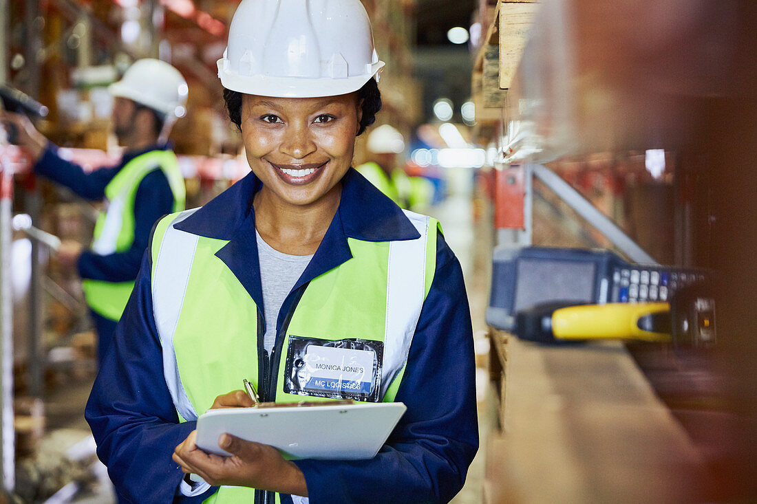 Portrait smiling female worker with clipboard