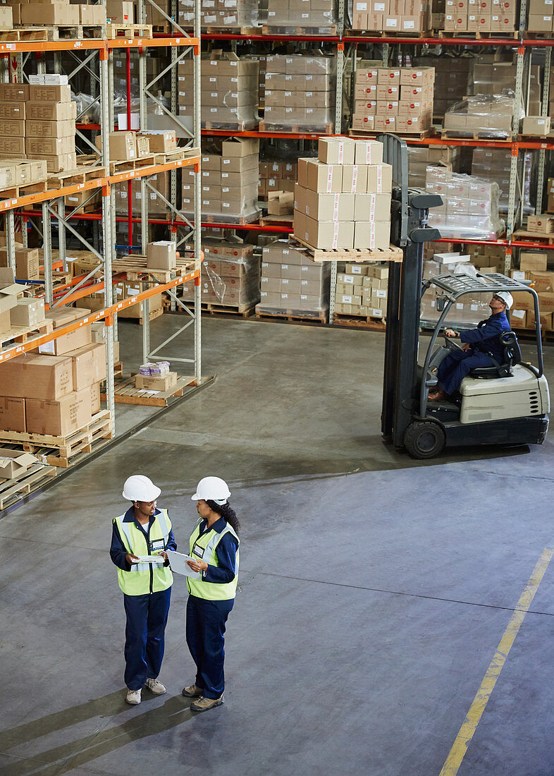 Forklift and workers meeting