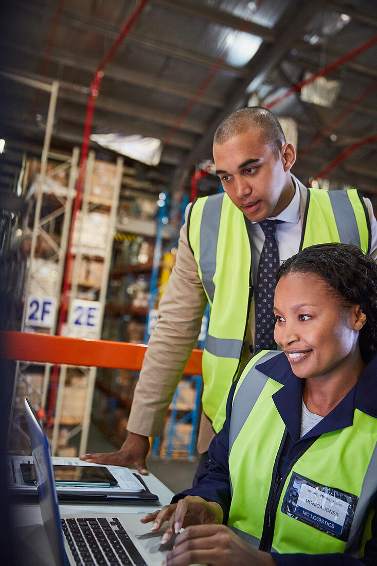 Manager and worker in distribution warehouse