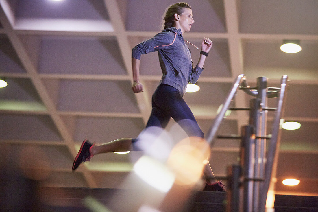 Female runner running above stairs