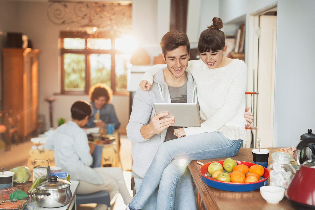 Smiling young couple in kitchen