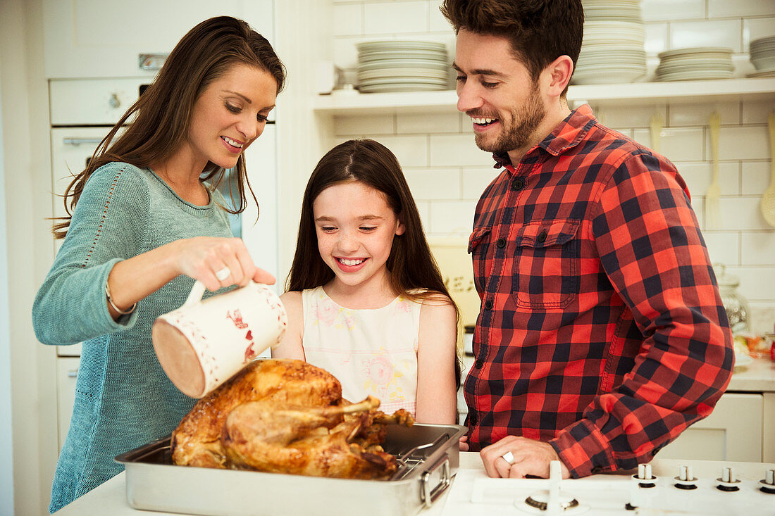 Family preparing Christmas dinner turkey