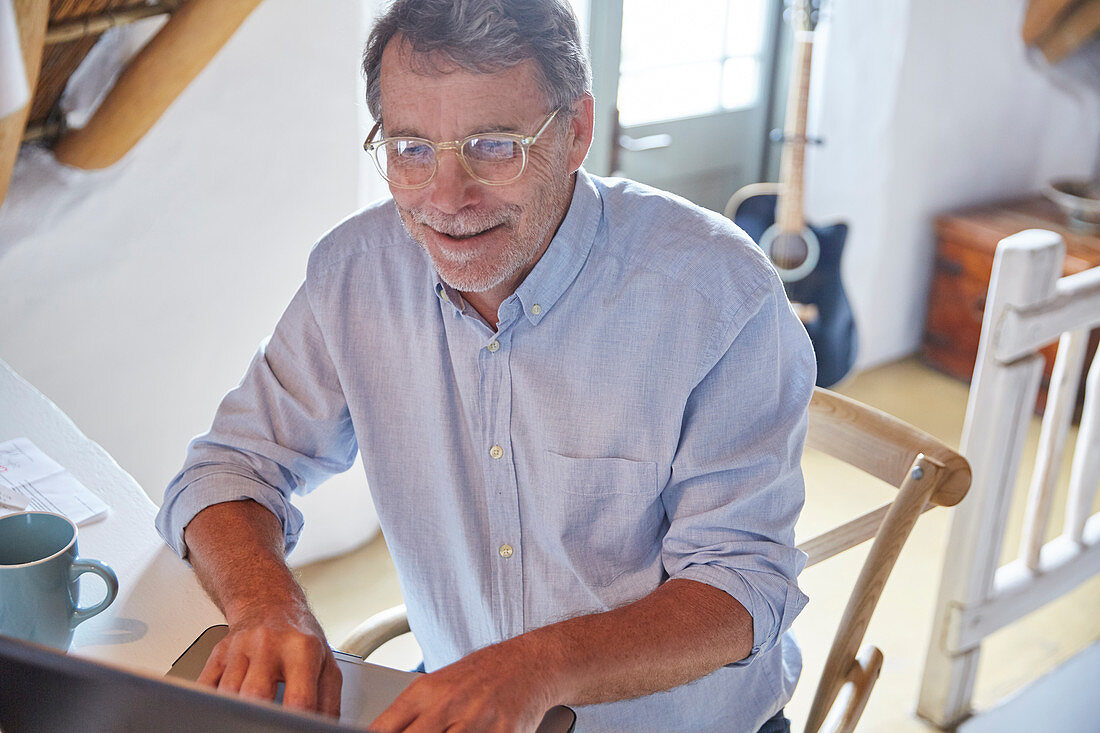 Senior man using laptop