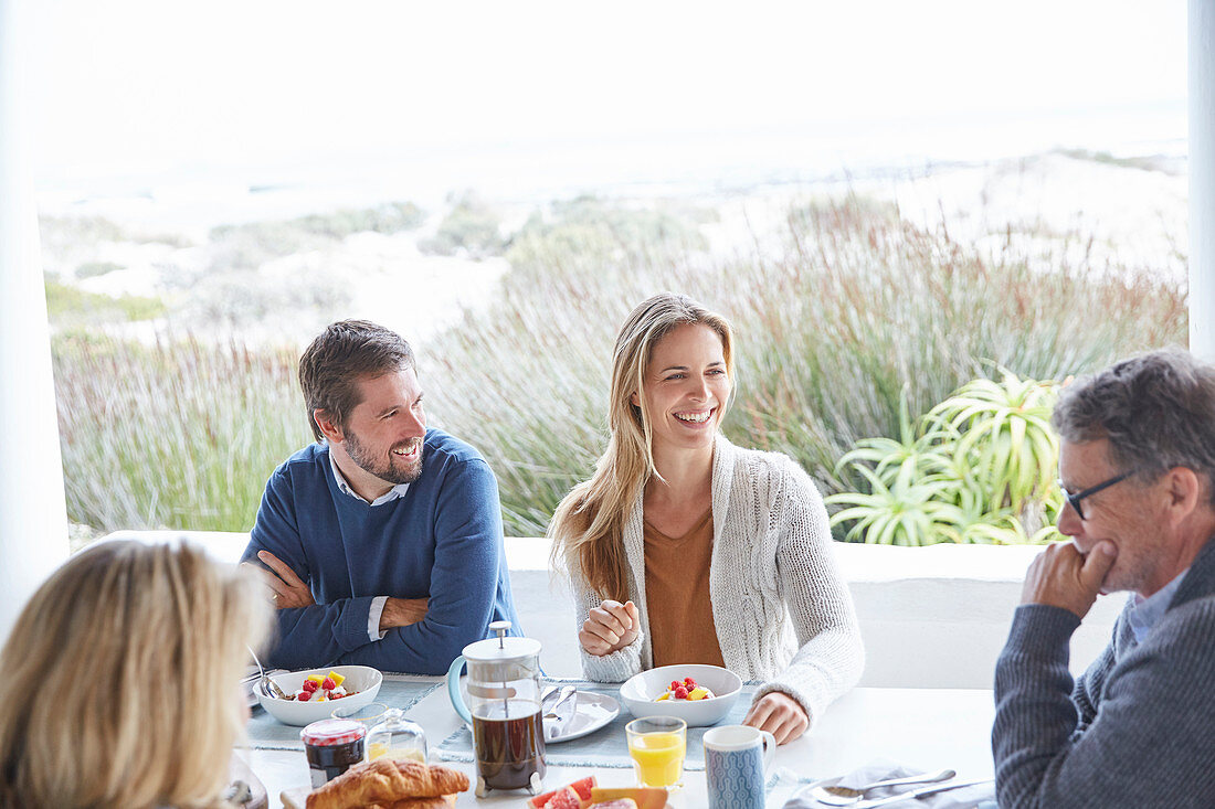 Couples enjoying breakfast on beach patio